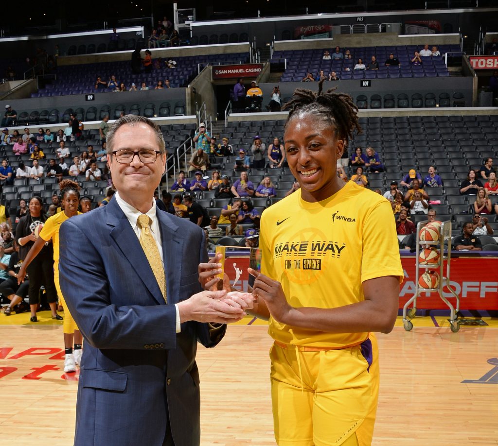 Todd DeMoss present an award to a WNBA Player.