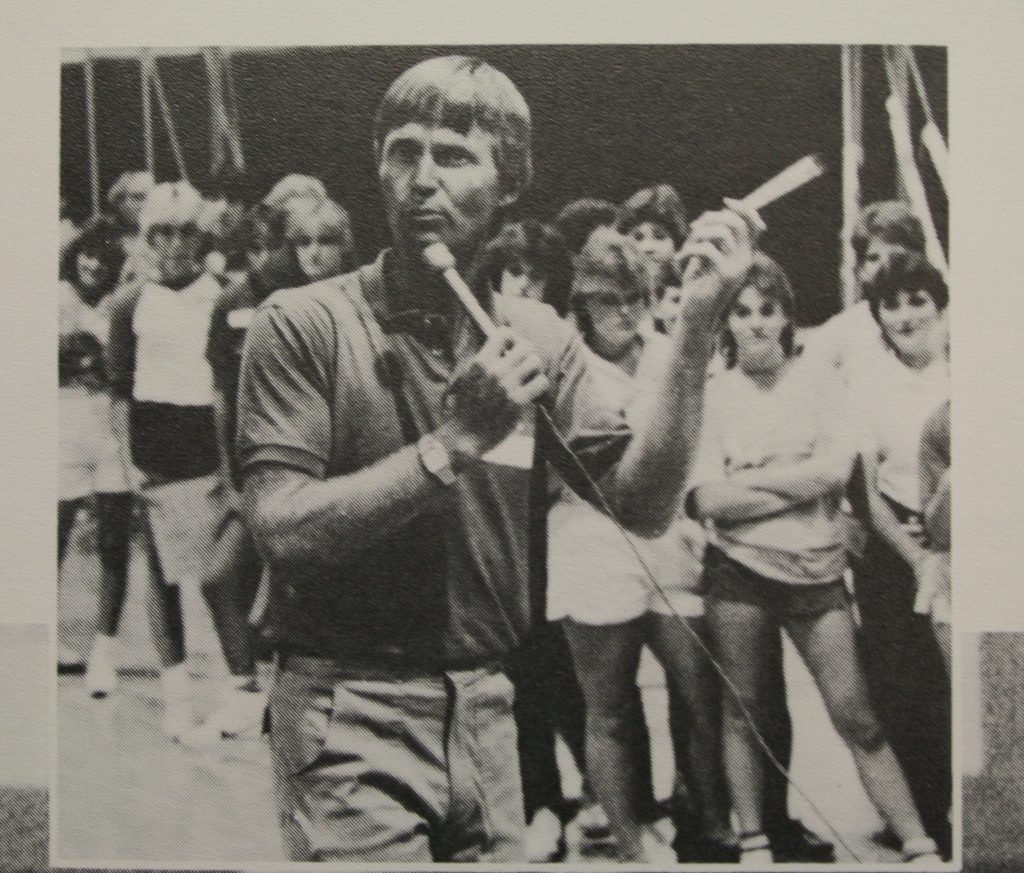Photo of high school principal Ken Steine leading a student cheer session in the mid 80s.. 