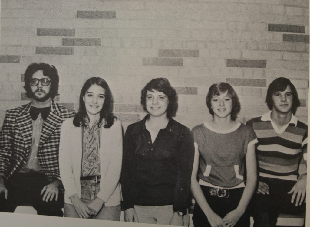 Five students from 1975 posing for a photo in the hallway at Prairie High School.  